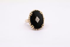 Vintage Black Onyx Ring. Oval Black Onyx in yellow gold with white gold trim and diamond accent  Black Onyx 18x13mm Oval  10k Yellow Gold    Genuine Diamond Accent .01ct  Finger Size 5 3/4 - can be sized upon request Black Oval Rings With Diamond Accents, Heirloom Black Oval Ring, Oval Black Diamond Ring In 14k Gold, Heirloom Black Diamond Oval Ring, Heirloom Black Oval Diamond Ring, Oval Black Enamel Diamond Rings, Princess Cut Diamond Band, Gold Circle Ring, Hammered Cuff Bracelet