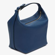 The Mochi bag is Valextra’s ode to contemporary elegance and material innovation. Crafted from our super soft Millepunte calf leather, it is a delight to hold and behold in this eye-catching sapphire blue hue. Inside this malleable everyday handbag there is space for everyday essentials that are kept secure by the easily gliding gold-tone zip fastening. Easily carried as a top-handle handbag or shoulder bag due to its extendable strap, it is appropriate for a myriad occasions. Finessed with our black lacquered Costa edging, its whispered credentials are cemented with its externally embossed foiled code that is unique to each handbag and the artisan who made it. Blue Luxury, Micro Bags, Everyday Handbag, Large Wallet, Top Handle Handbags, Backpack Travel Bag, Business Bag, Sapphire Blue, Small Accessories