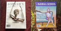 two magazines sitting on top of a wooden table next to a pair of reading glasses