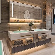 a bathroom with two sinks and a large mirror above the bathtub is lit by recessed lights