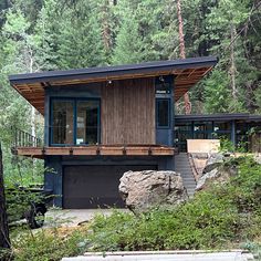 a house in the woods with stairs leading up to it