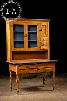 an old fashioned wooden desk with drawers and cupboards on it's sides, in front of a black background