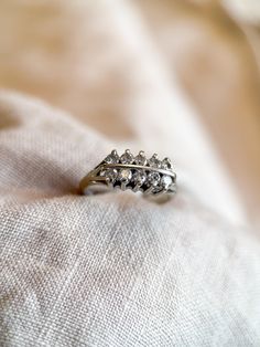 two rings sitting on top of a white cloth