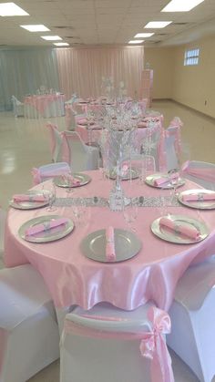 the tables are set with pink and white linens