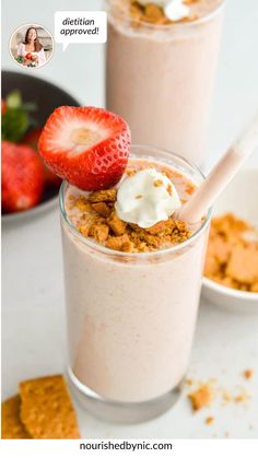 two desserts with strawberries and whipped cream in them on a white counter top