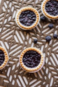 blueberry pies are arranged on a table