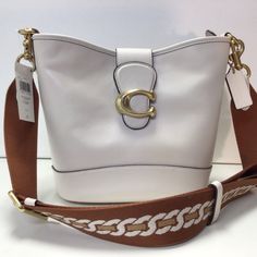 Nwt Coach Tali Leather Bucket/Shoulder Bag Color: Chalk (White) Style: Ca112 Leather Zippers And Magnetic Closures Fabric Lining Interior Snap Button Pocket Four Protective Feet At Base Removable Shoulder Strap For Shoulder Or Crossbody Carry Includes Interchangeable Strap Approx. 10.75" W X 8.75" H X 5" W Bag; 21.5" Strap; 23.5" Webbing Drop Designer White Leather Bucket Bag, Luxury White Shoulder Bag With Adjustable Strap, Luxury White Bucket Shape Shoulder Bag, Luxury White Bucket-shaped Bag, Designer White Bag With Adjustable Strap, Designer White Bucket Bag For Everyday Use, Designer White Bucket Bag For Travel, Designer White Bucket Bag, Designer White Bucket Shoulder Bag