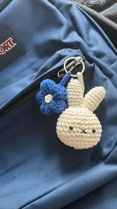 a crocheted bunny keychain hanging from a backpack