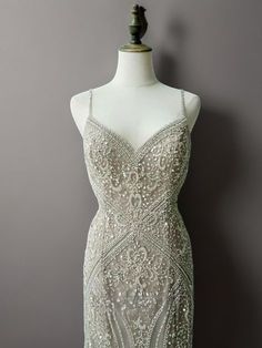 Step into a world of elegance and sophistication with our Elegant Champagne Beaded Sequin and Feather Dress. This enchanting gown features a stunning champagne hue that exudes luxury and grace. The bodice is adorned with intricate beadwork and shimmering sequins, creating a dazzling effect that is sure to turn heads. Intricate Beadwork and Sequins: The bodice is meticulously decorated with intricate beadwork and sequins, offering a touch of glamour and sophistication that enhances the dress's overall appeal. Delicate Spaghetti Straps: The elegant spaghetti straps provide a refined and graceful silhouette, adding to the dress's feminine charm. Feather Trimmed Hem: The dress cascades into a feather-trimmed hem, creating a dramatic and captivating finish that ensures all eyes will be on you. Sequin Champagne Dress, Nye Wedding Dress, Sequin And Feather Dress, Simple Satin Wedding Dress, Nontraditional Wedding Dress, Wedding Dresses High Low, Champagne Evening Dress, Fairy Wedding Dress, Nye Wedding