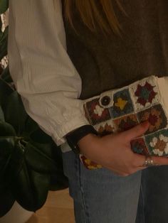 a woman is holding her purse in her hands