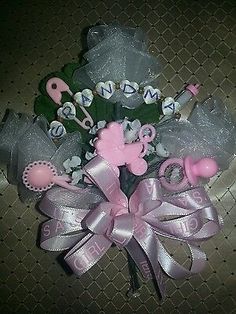 a pink and gray bouquet with scissors, hair clips, and other items on it