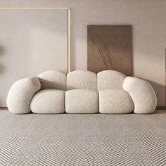 a white couch sitting on top of a carpet covered floor