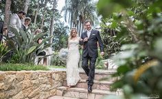 a bride and groom walking down some steps