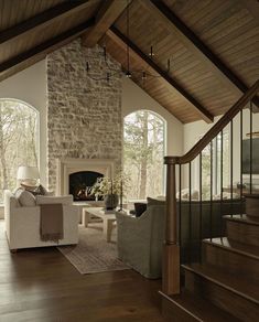 a living room filled with furniture and a fire place in the middle of a room