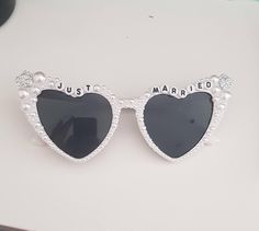 White heart shaped glasses encrusted with pearls. A glamorous touch for the newlywed White Heart Shaped Sunglasses, Wedding Heart Sunglasses, Heart-shaped Sunglasses For Summer Weddings, White Heart Sunglasses Bride, White Heart-shaped Beach Sunglasses, Bachelorette Sunglasses, Heart Shaped Glasses, Heart Glasses, Pearl Heart