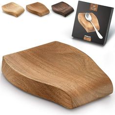 a wooden cutting board with four pieces of wood in front of it and a box on the other side