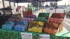 boxes are stacked on top of each other at an outdoor vendor's market stall