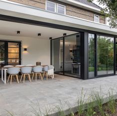 an outdoor dining area with table and chairs