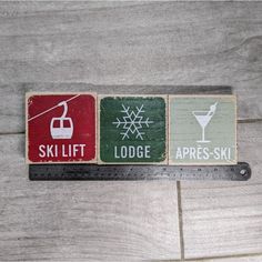 three wooden signs with ski lift, lodge, apres ski and lodge logo on them