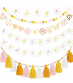 a garland with flowers and tassels hanging from it's sides on a white background