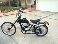 a black motorcycle parked in front of a house