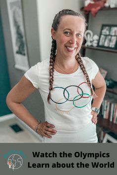 a woman with braids standing in front of a book shelf and smiling at the camera