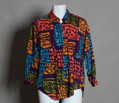 Vintage 70s 80s Men's long sleeve button down shirt - Purple with colorful designs. Whistles Sport size - S vintage pre-owned, light wear, a few TINY white specks Multicolor Retro Print Button-up Top, Casual Multicolor Blouse With Vintage Print, Retro Shirt With Vibrant Multicolor Print, Retro Multicolor Relaxed Fit Blouse, Retro Relaxed Fit Multicolor Blouse, Multicolor Retro Print Shirt For Fall, Multicolor Long Sleeve Shirt With Vintage Print, Vintage Multicolor Shirt With Colorful Pattern, Multicolor Vintage Shirt With Colorful Pattern