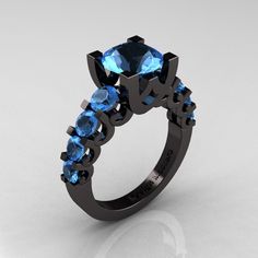 a black ring with blue stones on it