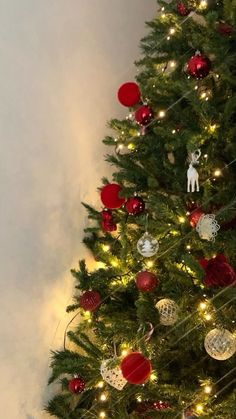 a decorated christmas tree with red and silver ornaments