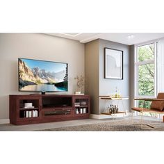 a flat screen tv sitting on top of a wooden entertainment center in a living room