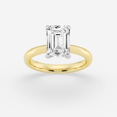 an emerald - cut diamond ring in yellow gold