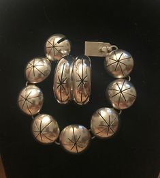 Taxco Mid century Modern Bracelet & earrings set.  Demi parure set.  Starburst design.  1950s 1960s. Space age.  Quintessentially MCM Mexico.  Bracelet: Measures 7 1/2" (7 1/4" wrist) Half dome hollow panels.  7/8" diameter.  Working secure clasp.  Slide in clasp.  Marked: TV-140 Mexico 925.  Hoop Earrings: Measure:  1 3/8" diameter.  1/2" width.  Pierced. French wire.  Marked: TM-159 Mexico 925.  Large but not weighty.  Statement pieces.  Previously owned.  Excellent vintage condition.  I polis Mid-century Handmade Formal Jewelry, Mid-century Polished Formal Jewelry, Vintage Silver Jewelry With Matching Earrings, Mid-century Bracelet Jewelry Gift, Mid-century Polished Finish Jewelry For Anniversary, Mid-century Round Jewelry Gift, Nickel-free Retro Jewelry For Anniversary, Retro Nickel Free Jewelry For Anniversary, Vintage Sterling Silver Clasp Jewelry For Anniversary