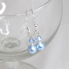 Sophisticated sparkle, perfect for weddings or other special occasions.  These gorgeous 'something blue' earrings have genuine Swarovski crystals and pearls, and hang on sterling silver earwires. These earrings can be ordered as a set for you and your bridesmaids - a discount is available on multiple pairs and other colour schemes can be made to order. A matching necklace is also available (last photo) - http://www.etsy.com/uk/listing/555521469/blue-bridal-necklace-something-blue Elegant Light Blue Crystal Earrings For Gift, Classic Blue Pearl Earrings For Wedding, Light Blue Sterling Silver Earrings For Wedding, Light Blue Sterling Silver Wedding Earrings, Elegant Light Blue Crystal Earrings For Party, Elegant Light Blue Hypoallergenic Earrings, Blue Bridal Earrings, Cube Necklace, Diy Jewelry Unique