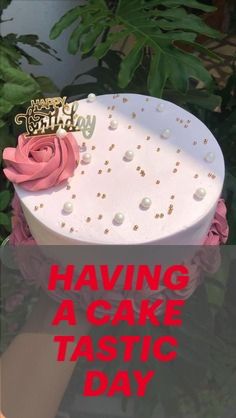 a white cake with pink flowers on it and the words having a cake taste day