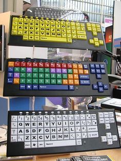 there are many different keyboards on the table together in this office area, including one for each type of keyboard