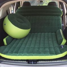 an inflatable car seat is sitting on the back of a vehicle with its trunk open