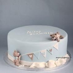 a blue cake decorated with teddy bears and bunting