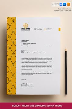 a yellow and black business letterhead on top of a white paper next to a pencil