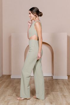 Our Lennon Jumpsuit is now available in all our crepe colors, making it the perfect option for the bridesmaid who desires a unique and edgy alternative to a dress! Lennon is modern and elevated in its design, featuring a one-shoulder draped bodice and a mid-size side cut-out that hits near the waist on the left side with wide straight-leg pants, creating a feeling of effortless beauty. FEATURES: Fitted silhouette One shoulder neckline, thick shoulder strap on the left side Built-in bra cups and Elegant Spring Jumpsuits And Rompers With Back Opening, Chic Sleeveless Jumpsuit For Wedding Guest, Spring Wedding Fitted Jumpsuits And Rompers, Sleeveless Spring Wedding Pantsuit, Chic Spring Wedding Jumpsuits And Rompers, Chic Bridesmaid Jumpsuits And Rompers, Fitted Jumpsuits And Rompers For Wedding Guest In Spring, Fitted Summer Jumpsuit For Bridesmaids, Fitted Sleeveless Bridesmaid Jumpsuits And Rompers