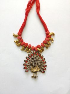 Here's an Indian Vintage Oxidized Necklace you can show off your style with! It's bold, it's beautiful and it's sassy! Grab on this Gold Peacock Oxidized Necklace embedded with red stones and thread chain. Specifications: Vintage Necklace Bird Pendant - Peacock Gold Oxidized Plating Mixed Metals Red Glass Stone Bold Statement Jewelry Festive Red Peacock Design Necklace, Red Peacock Design Temple Jewelry Necklace, Red Temple Jewelry Necklace With Peacock Design, Elegant Red Necklace With Peacock Design, Festive Red Jewelry With Peacock Design, Red Adjustable Temple Jewelry Necklace, Red Peacock Design Necklace As A Gift, Red Peacock Design Necklace As Gift, Red Peacock Design Necklace For Gift