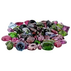 many different colored stones on a white background