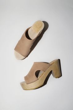 Open toe clog slide on platform heel. Smooth, pale beige nubuck upper. Side cut outs and double-needle stitching. Lacquered, lightweight wood base. Unlined. Every clog is handmade. Textures of leather can vary from shoe to shoe. Certain styles may take up to 10 business days to arrive. DETAILS Water repellant cow leather upper. Wood base with polyurethane sole. 4" heel with 2" front platform. Handmade in the U.S. FIT & FEEL Ideal for regular to wide widths. This style can start off snug, leather Pale Beige, No 6, Side Cuts, Platform Heel, Slide On, Cut Outs, Platform Heels, Cow Leather, Open Toe