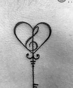 a heart and key tattoo on the back of a woman's neck