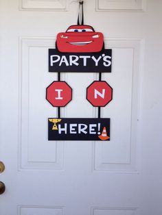 this is a door decoration with cars and stop signs on it that says party's in here