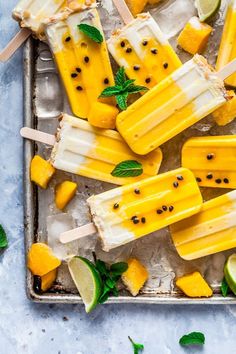 popsicles made with mango, lime and mint are on a tray ready to be eaten