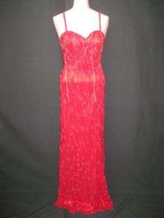 "This beautiful long red gown has red and silver beading. It is fitted along the body through the hips and flares at the very bottom.  It has a sweetheart neckline and bare back with straps across it.  This gown is in excellent condition and comes in different sizes.  Measurements for this gown in red/silver are :                                                                                                                                                   Black/silver Size-4 Red Gown For Pageant During Prom Season, Sweetheart Neckline Evening Dress With Fitted Bodice For Pageant, Pageant Evening Dress With Corset Back And Fitted Bodice, Floor-length Evening Dress With Fitted Bodice For Pageants, Red Sleeveless Gown For Pageant, Red Gown For Pageant And Prom Season, Red Sleeveless Gown For Pageants, Sweetheart Neckline Gown With Beaded Straps And Fitted Bodice, Sparkling Floor-length Gown For Pageants