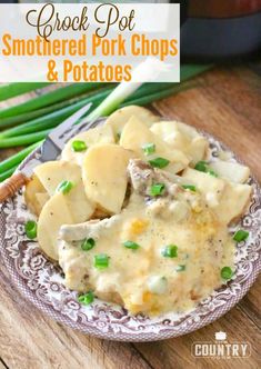 crock pot smothered pork chops and potatoes on a plate with asparagus