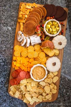 a wooden platter filled with different types of snacks