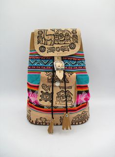 Beautiful Backpack/Bag handmade from Peru. Backpack is made of artisan people of genuine leather with multicolor Aguayo fabric from Peru. Aguayo is a native textile made by native indigenous women from the Andes. SIZE:  Height: 10'', Depth: 3'', Width: 7'', 2 Straps Drop: 21'' each  Weight:  0.12 lb.  Material: 100% Genuine Leather and Aguayo cloth (Traditional Fabric from Andes) made of wool. Made in Peru. Bohemian Brown School Bag, Brown Bohemian School Bags, Bohemian Multicolor Backpack For School, Traditional Multicolor Backpack For Travel, Multicolor Rectangular Leather Backpack With Adjustable Strap, Handmade Multicolor Standard Backpack, Bohemian Style Brown Backpack, Bohemian Brown Standard Backpack, Bohemian Natural Color Backpack