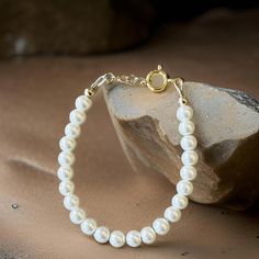 Key Features: ~14K Gold Finishings ~White Pearl Beads ~14K Gold Filled Clasps with 1/2" extension loops (Easy to adjust, allowing the bracelet to grow with your baby)  THERE ARE NO RETURNS OR EXCHANGES FOR WRONG SIZE. To ensure proper sizing, please measure your baby's wrist before you purchase. Use a soft measuring tape tightly and add 1/2" to find the correct size. WARNING: CHOKING HAZARD Never leave a child unattended with a bracelet on. Elegant Round Jewelry For Baptism, Elegant Pearl White Jewelry For Baptism, Elegant Beaded Jewelry For Baptism, Elegant Pearl Jewelry For Baptism, Classic Adjustable Jewelry For First Communion, Elegant Round Beads Bracelets For First Communion, Classic White Pearl Bracelet With Gold Beads, Gold Pearl Jewelry For Baptism, Elegant Round Beads Bracelet For First Communion